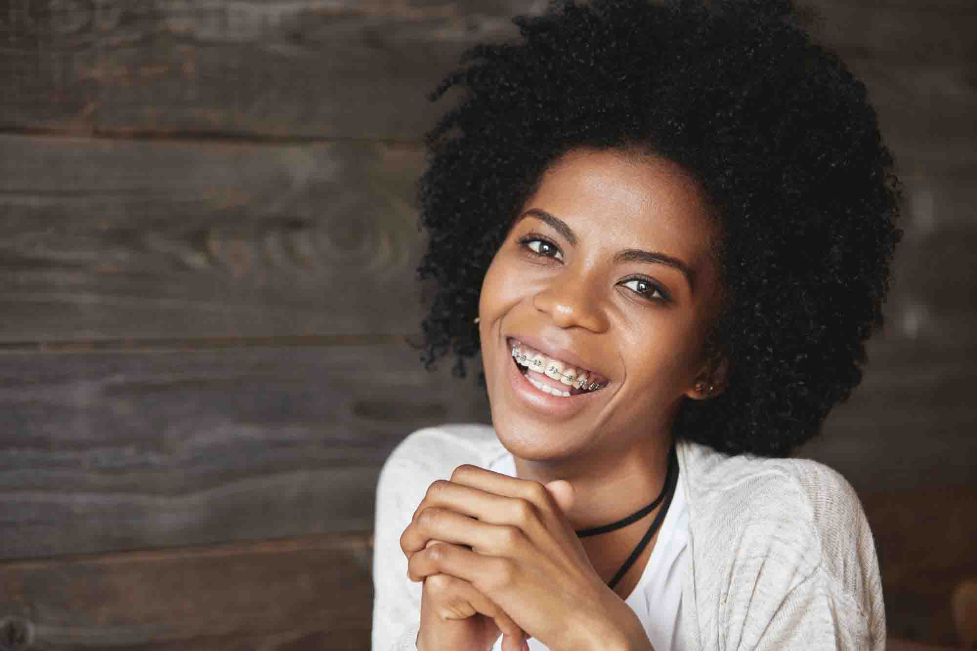 Adult woman smiling with braces.
